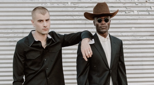 Left to Right: Blake wears shirt Calvin Klein, trousers Yves Saint Laurent, and vintage cowboy boots. Remi wears cowboy hat Stetson, suit Balmain, vintage French shirt and cowboy boots.