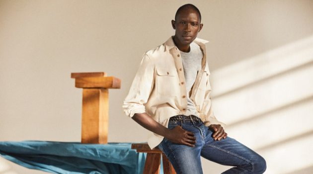 Medium Denim: A chic vision, Armando Cabral wears distressed denim jeans with an off-white oversized shirt.