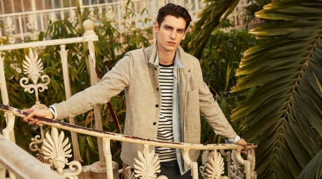 Anthony Gilardot wears a striped slub jacket, jersey t-shirt, shorts, and linen shirt by Mr P.