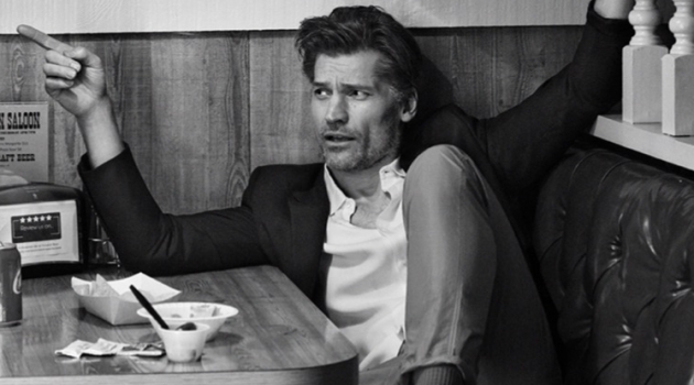 Actor Nikolaj Coster-Waldau sports a Sandro shirt, Prada suit jacket, Moncler 2 pants, and Lanvin sneakers.