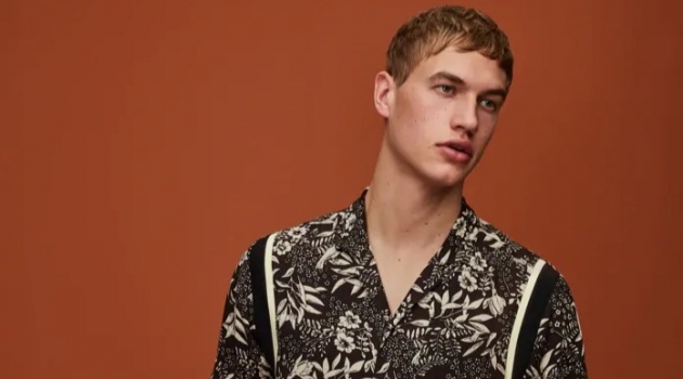 Mixing prints, Paul François wears a Hawaiian print shirt and pinstripe pleated trousers by Scotch & Soda.