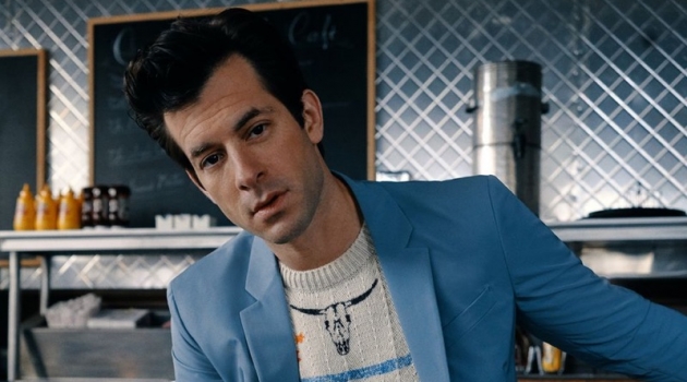 Front and center, Mark Ronson sports a light blue Prada suit with a Saint Laurent sweater.