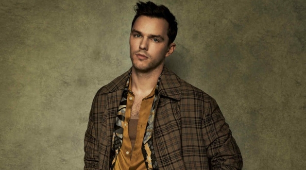 Front and center, Nicholas Hoult sports a check Hermès coat over a Roberto Cavalli coat. The actor also dons a Sean Suen shirt and Margaret Howell trousers with an Anderson's belt.