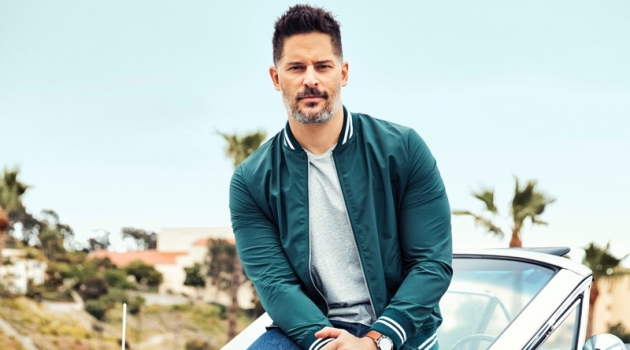 Actor Joe Manganiello wears an Eleventy jacket, Calvin Klein t-shirt, Levi's jeans, and Converse sneakers with a Movado watch.