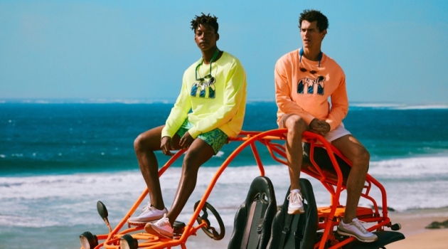 Taking to the beach, Ty Ogunkoya and Vincent LaCrocq sport highlighter-colored tees and swim shorts from Mango's Mistral collaboration.