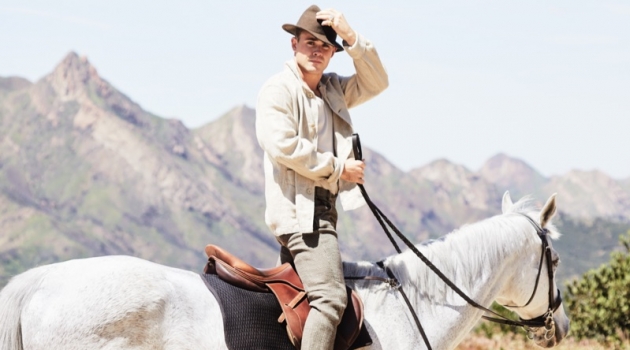 Riding a horse, Dacre Montgomery sports an Our Legacy linen jacket, Billy tank, Man 1924 trousers, and Golden Goose sneakers.