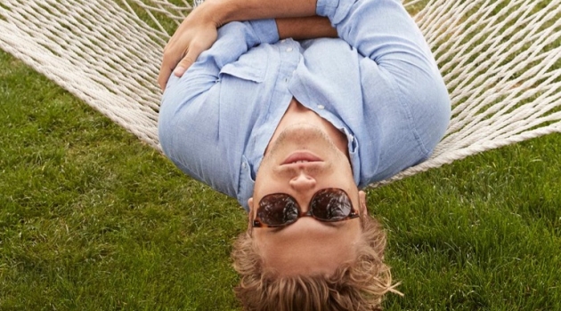 Taking in a relaxing day in Palm Springs, Christopher Mason dons Warby Parker's Tilden acorn tortoise with gold sunglasses.