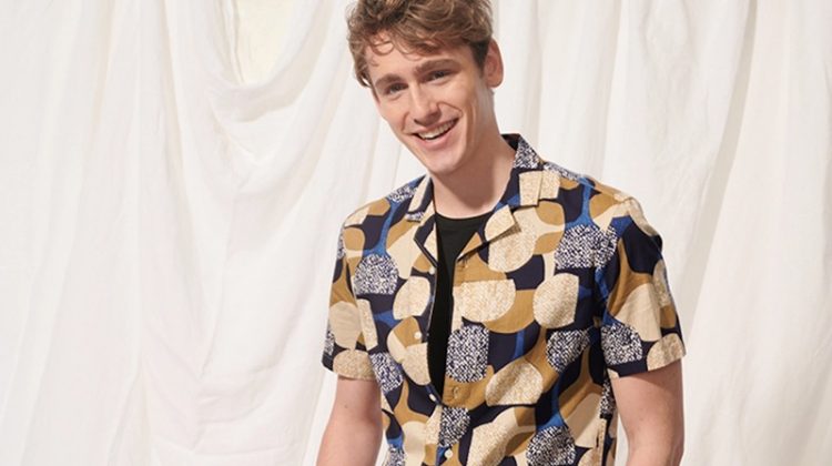 All smiles, Tom Webb wears a Club Monaco notched collar moon print shirt $89.50 and 7" shorts $89.50.