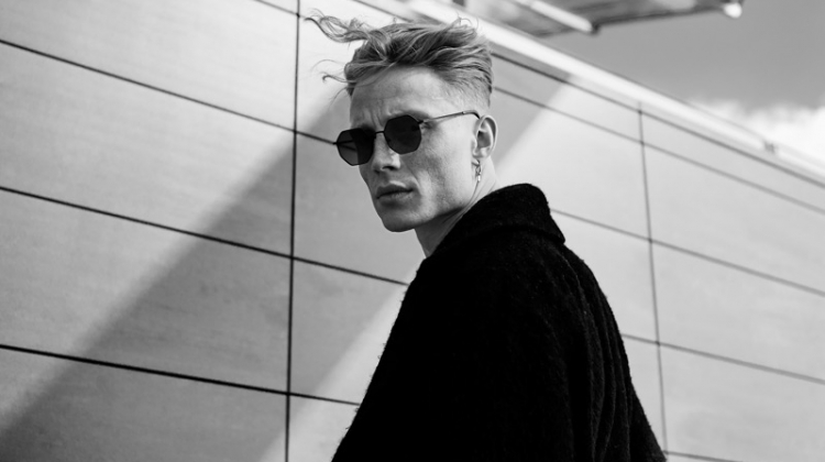 A cool vision, Jan Siegmund dons an oversized coat and sunglasses.