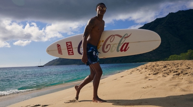 Taking to the beach, Timothy Lewis rocks swim shorts from the KITH x Coca-Cola capsule collection.