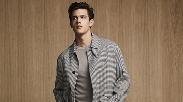 Xavier Serrano sports a chic checked coat with pleated trousers and a sweater from Liu Jo Uomo.