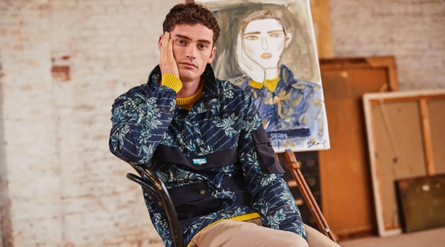 Wearing Scotch & Soda, Harrison Alexander Griffiths poses with an illustration by Blair Breitenstein.