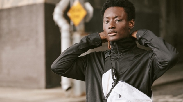 Reuniting with East Dane, Youssouf Bamba sports a Y-3 track jacket, cropped pants, and sling bag.