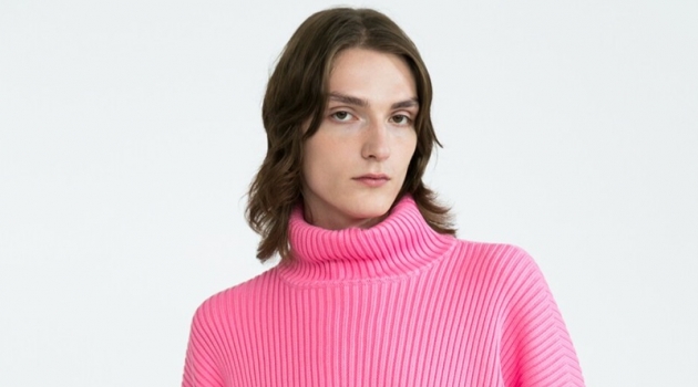 Alex Rychkov sports a pink ribbed Balenciaga turtleneck sweater $1290 and Versace jeans $525.