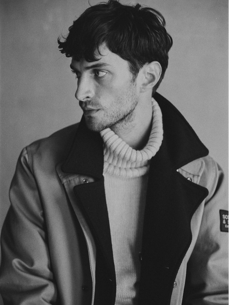 Connecting with Scotch & Soda, Matthew Bell models the brand's twill jacket $385 with a turtleneck sweater.