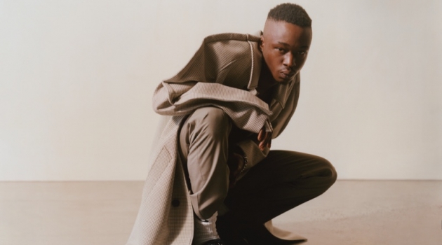 Connecting with MatchesFashion, Ashton Sanders rocks a Maison Margiela coat and trousers with Bottega Veneta shoes.