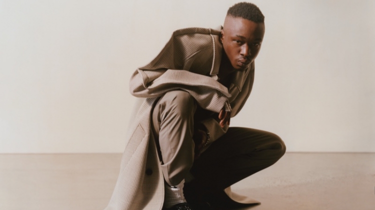 Connecting with MatchesFashion, Ashton Sanders rocks a Maison Margiela coat and trousers with Bottega Veneta shoes.