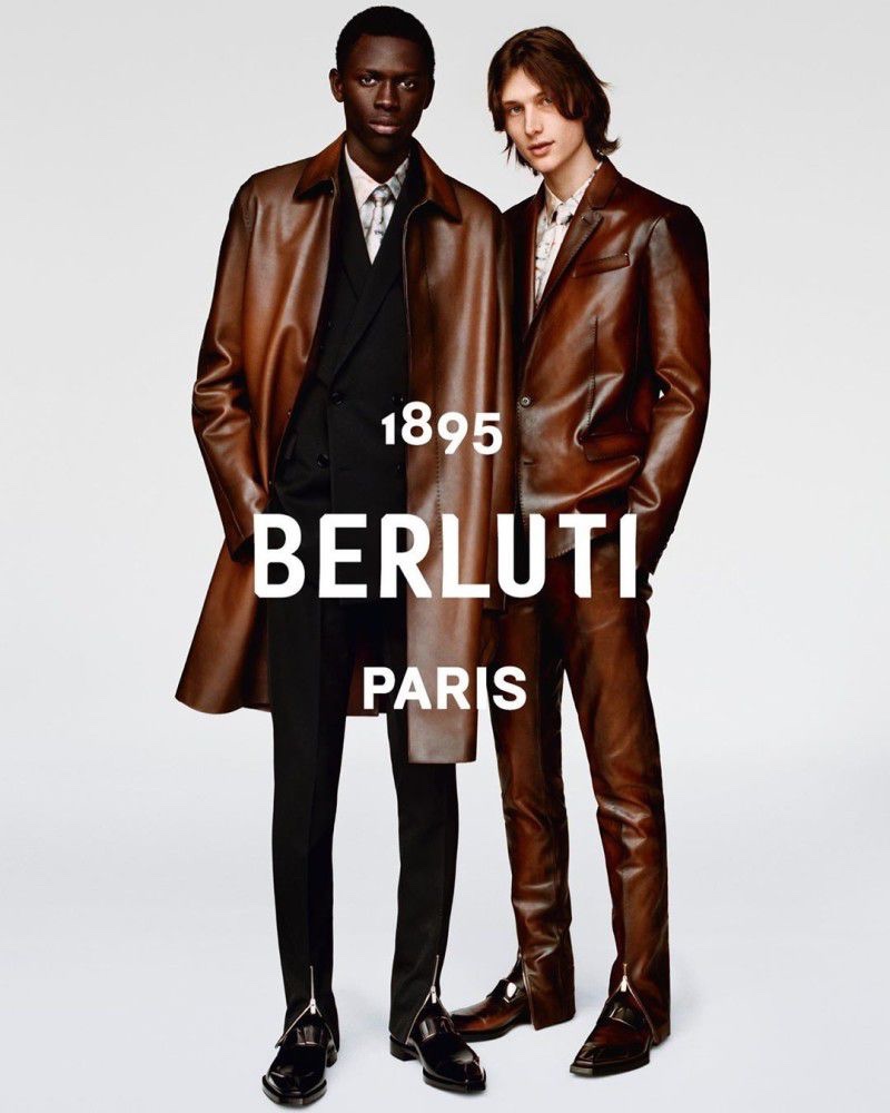 Donning brown leather suiting and outerwear, models Khadim Sock and Wellington Grant front Berluti's fall-winter 2019 campaign.