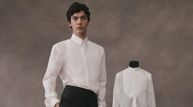 Lev Uliesov dons a sleek white and black tailored look from the Givenchy Atelier collection.