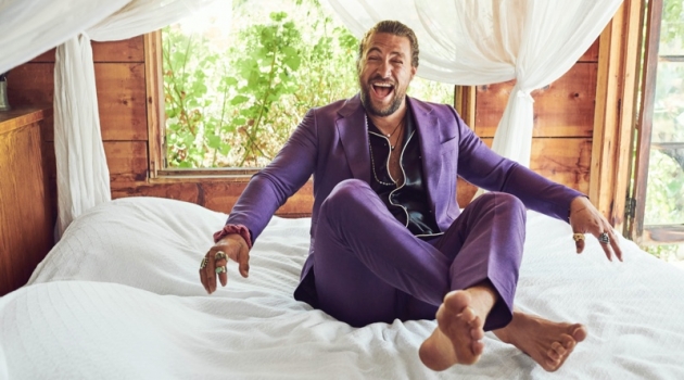 All smiles, Jason Momoa wears a shirt and purple suit by Gucci. His accessories put the spotlight on Rainbow Gems, Red Rabbit Trading Co., Book of Alchemy, and Leroy's Wooden Tattoos.