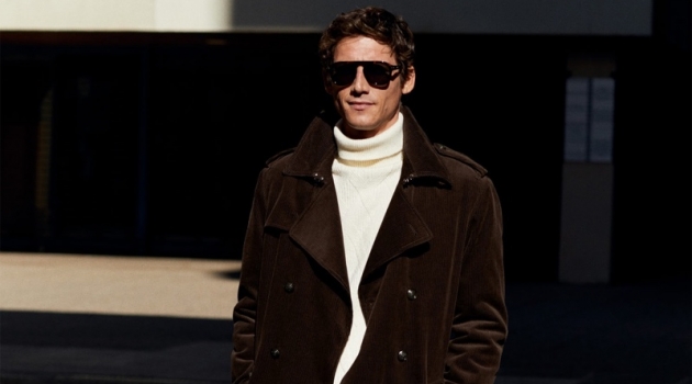 Roch Barbot dons a brown corduroy trench coat with a turtleneck sweater and trousers from Mango.