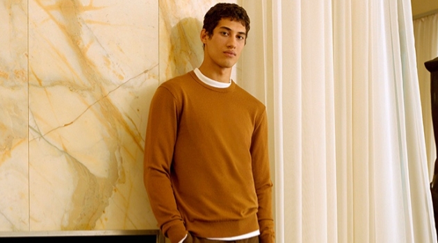 Malik Al Jerrari sports a brown sweater with wool flannel trousers from Club Monaco.