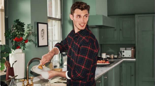 Doing the dishes, Kit Butler sports a H&M regular fit flannel shirt.