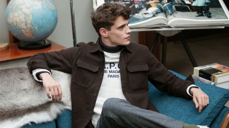 Relaxing, Jordy Baan sports an A.P.C. shirt jacket, Champion sweatshirt, Club Monaco houndstooth trousers, and Onitsuka Tiger California 78 EX sneakers.