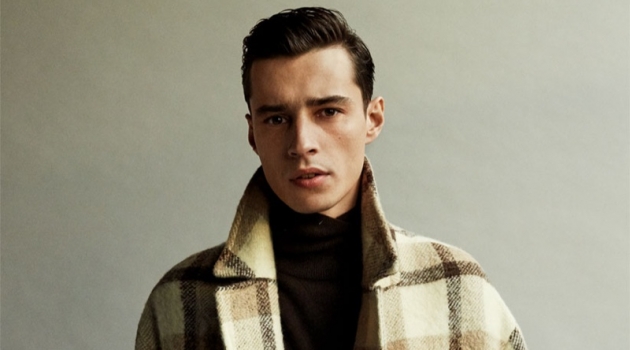 Front and center, Adrien Sahores dons a checked coat from Zara.