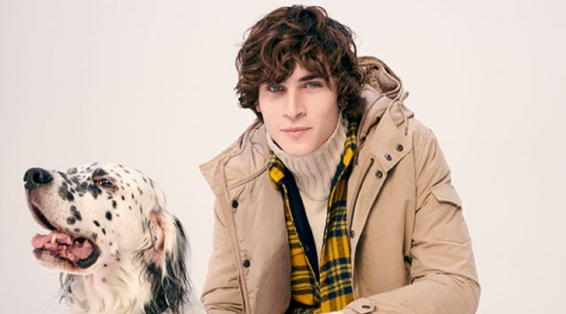 Ready for an outdoors excursion, Liam Kelly layers in a parka and turtleneck sweater.