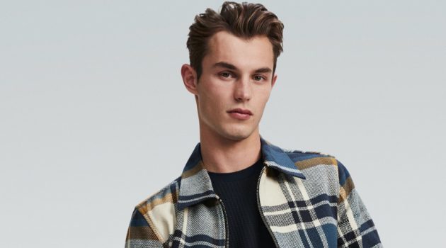 Kit Butler rocks a checked jacket and denim jeans for River Island's spring 2020 campaign.