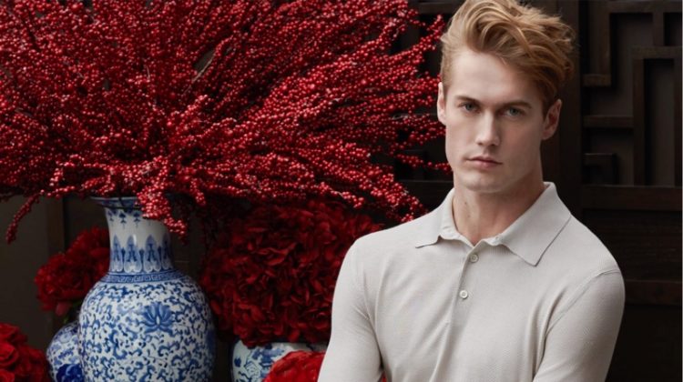 A chic vision, Neels Visser models a long-sleeve polo with pleated trousers from Ermenegildo Zegna for Holt Renfrew.