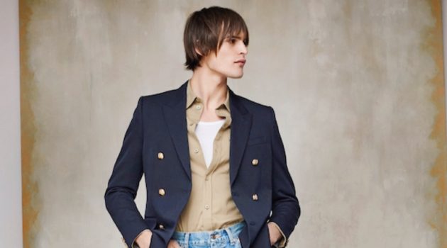 Holt Renfrew makes a case for relaxed tailoring as Parker van Noord sports a look from Celine. The top model wears Celine's double-breasted blazer, military shirt, tank, flared jeans, and sneakers.