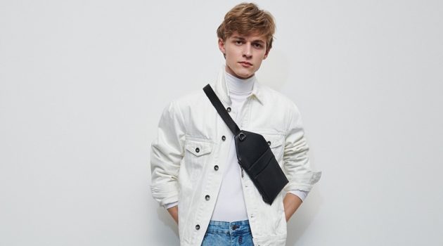 Mixing denim, Max Barczak wears a white trucker jacket and blue rinse jeans from Reserved.