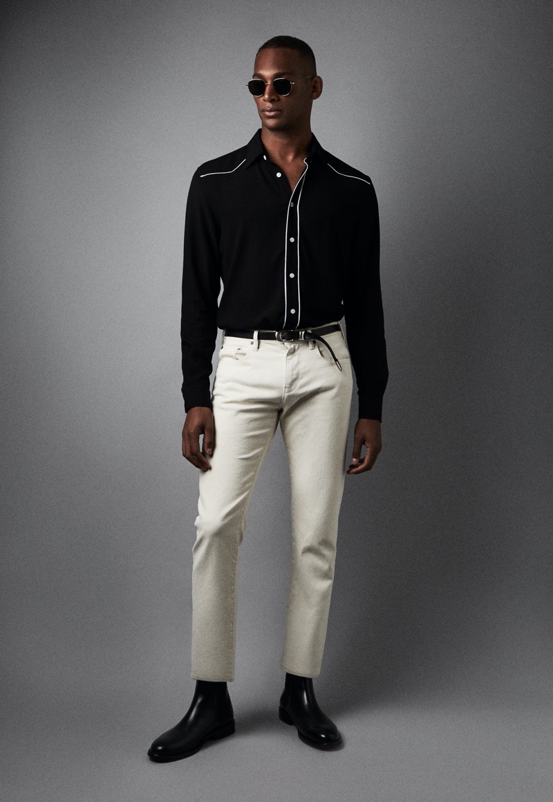 Front and center, Patrick Nodanche wears Reiss' Mayvis western shirt in black with Etna jeans and Tenor boots.