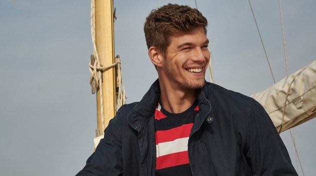 Embracing nautical style, Bertold Zahoran wears a striped t-shirt, casual jacket, and chinos from Barbour.