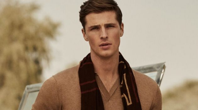 Edward Wilding models a short-sleeve tricot polo shirt with Pima cotton chinos and a printed logo scarf from Pedro del Hierro.