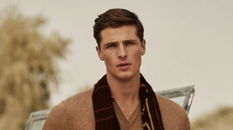Edward Wilding models a short-sleeve tricot polo shirt with Pima cotton chinos and a printed logo scarf from Pedro del Hierro.