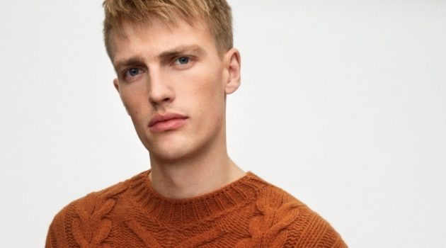 Victor Nylander dons a brown cable-knit sweater from Marc O'Polo's fall-winter 2020 casual collection.