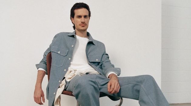 Figurative artist Tristan Pigott connects with COS for fall. He poses in the brand's organic cotton utility-style denim overshirt with a pair of recycled cotton denim cargo trousers.