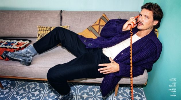 Taking a phone call, Pedro Pascal dons a cardigan sweater by Givenchy. Posing for GQ Germany, Pascal's look is complete with Junya Watanabe pants, a POLO Ralph Lauren tank, and vintage boots.