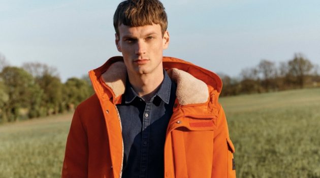 Max Bender rocks an orange hooded jacket for Esprit's fall-winter 2020 campaign.