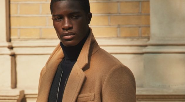 James Kakonge dons a sleek camel coat from Mr Porter's fall-winter 2020 Mr P. collection.