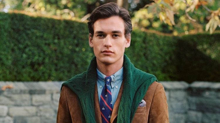 Jegor Venned is a posh vision in fall menswear from POLO Ralph Lauren. The top model dons a brown suede blazer with a POLO denim shirt and cable-knit sweater in green.