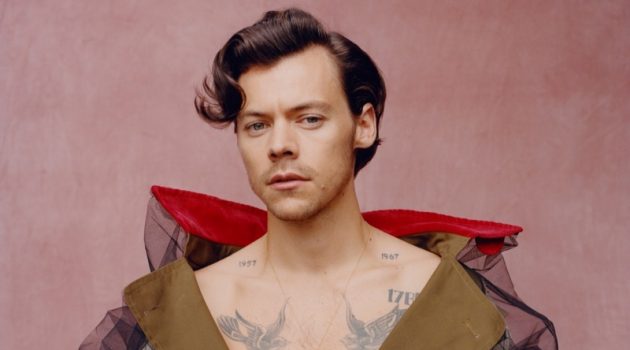 Front and center, Harry Styles wears a trench coat by Maison Margiela for Vogue.