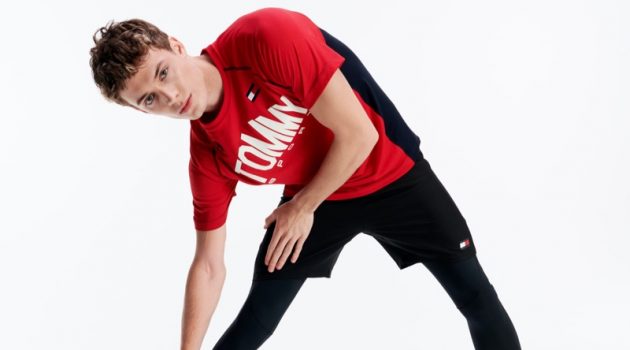 Stretching, João Knorr wears activewear from Tommy Sport.