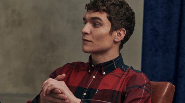 Relaxing, George Admiraal wears a red tailored shirt from Barbour's new Tartan collection.