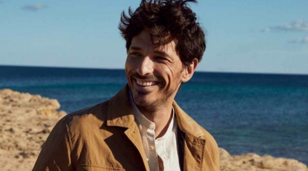 All smiles, Andres Velencoso wears a linen jacket and shirt with white jeans from Esprit's spring-summer 2021 men's collection.