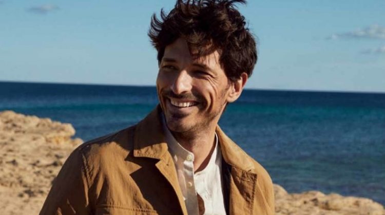 All smiles, Andres Velencoso wears a linen jacket and shirt with white jeans from Esprit's spring-summer 2021 men's collection.