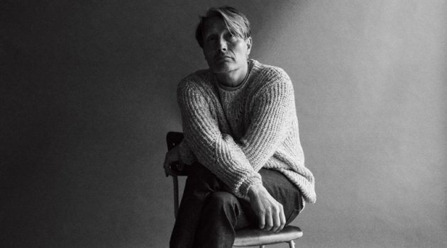 Mads Mikkelsen dons an Isabel Marant sweater with a Nanushka t-shirt, and A.P.C. jeans for WSJ Magazine.